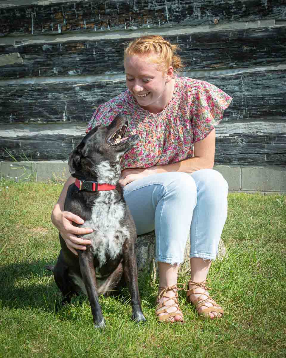 Girl sitting with family dog