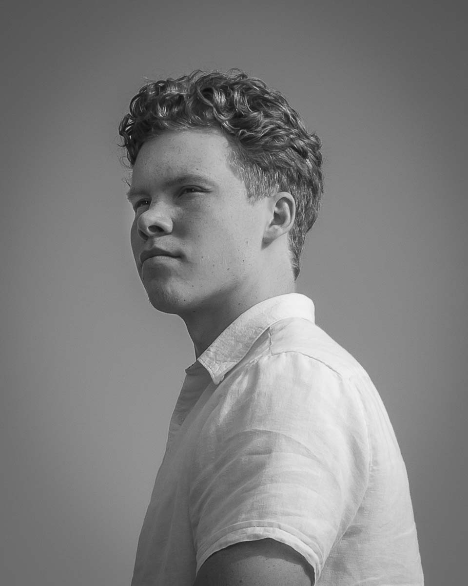 Black and white image of a senior looking into the distance