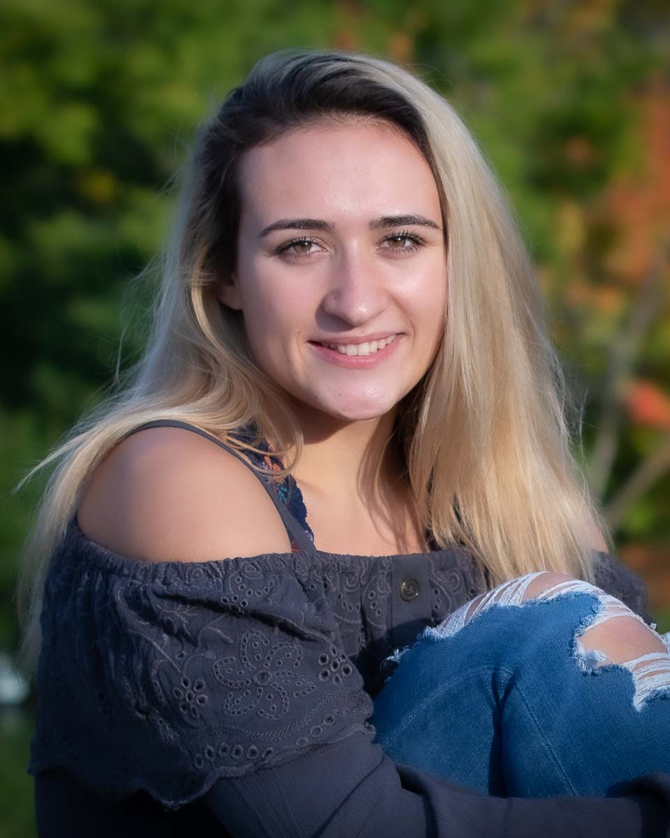 Portrait of a senior girl sitting in grass