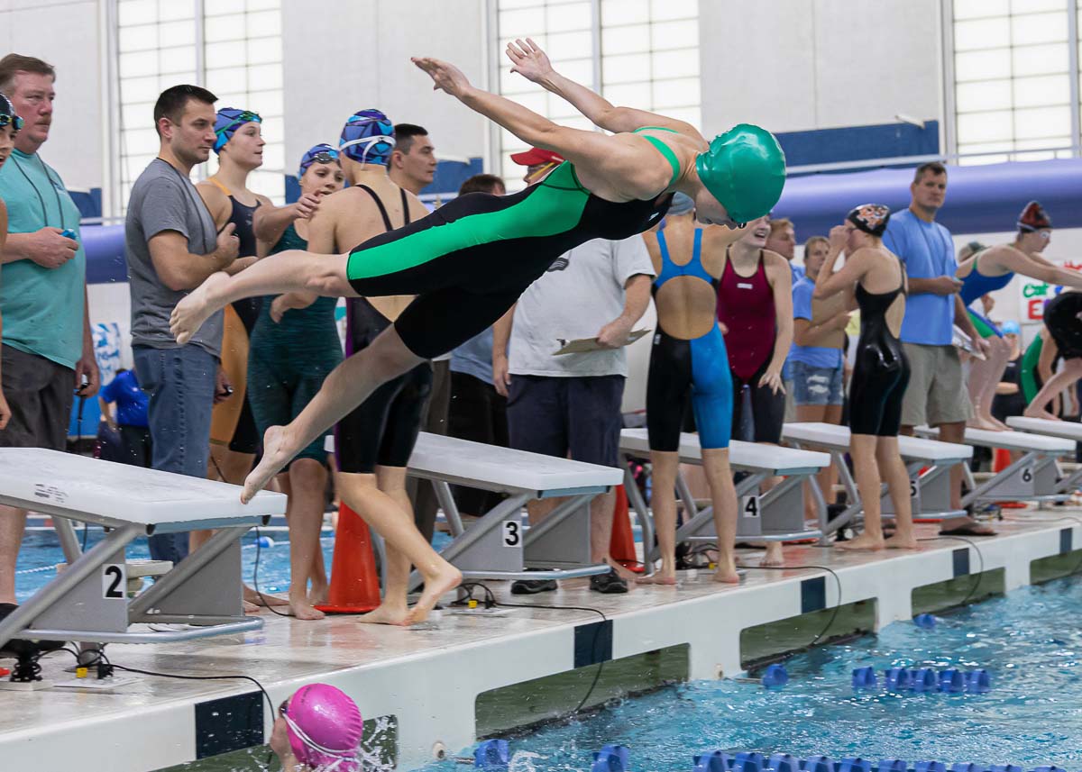 Girl entering water for swim race