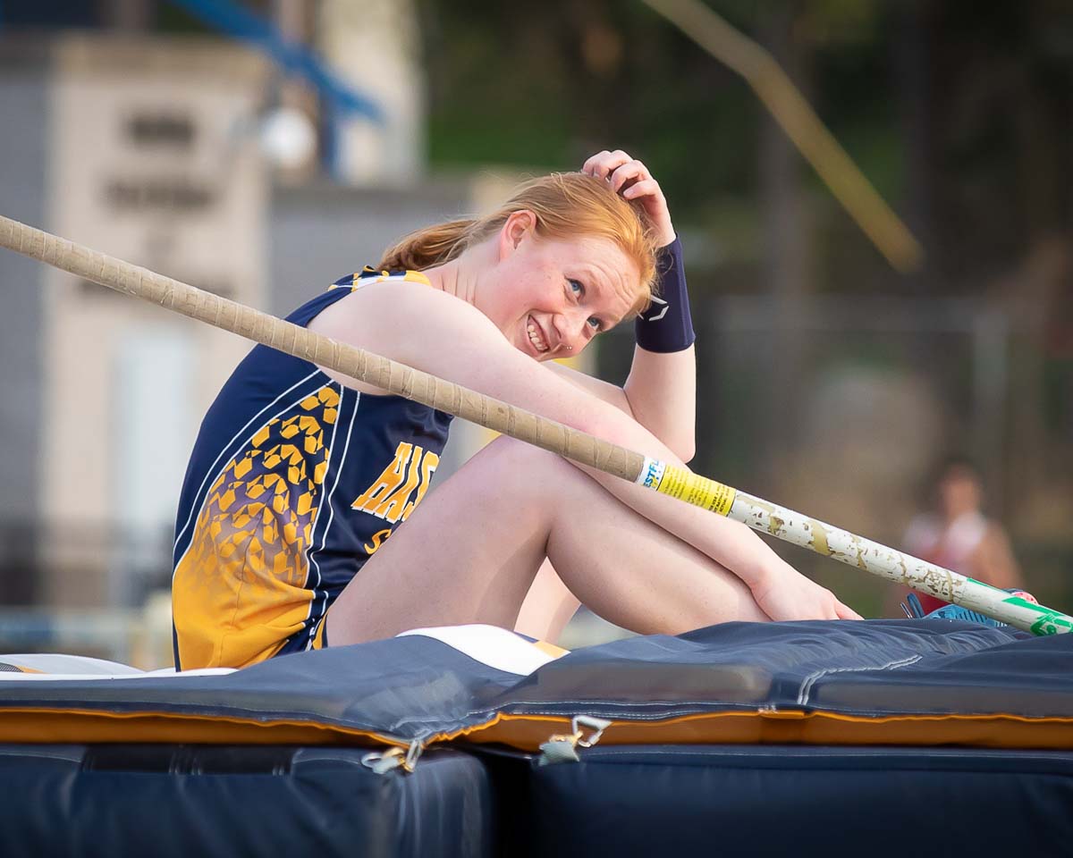Girl sitting on pole vault pad